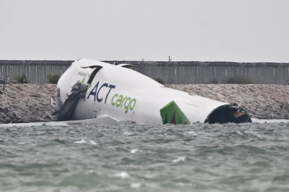 Two killed as cargo plane skids off Hong Kong runway Two killed as cargo plane skids off Hong Kong runway